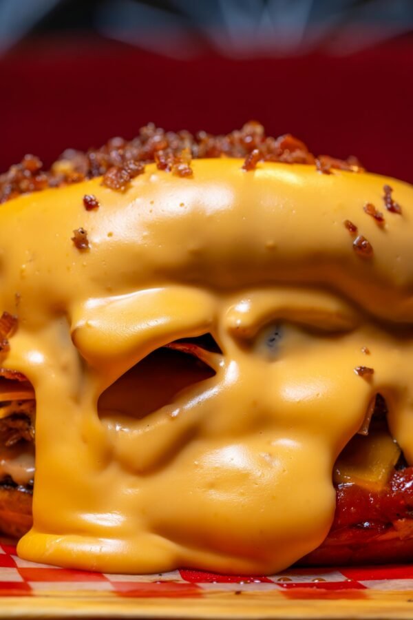 Delicious close-up of a cheeseburger covered in melted cheese, showcasing fast food appeal.