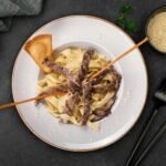 Plate of beef stroganoff with fettuccine pasta, perfect for gourmet dining.