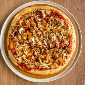 Savor a mouthwatering BBQ chicken pizza with melted cheese and onions.