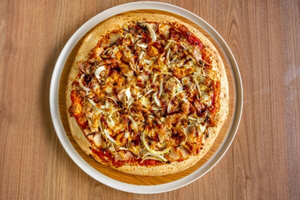 Savor a mouthwatering BBQ chicken pizza with melted cheese and onions.