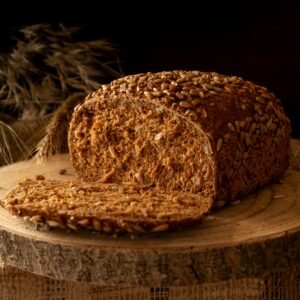 Freshly baked wholegrain bread loaf with sunflower seeds, perfect for breakfast.