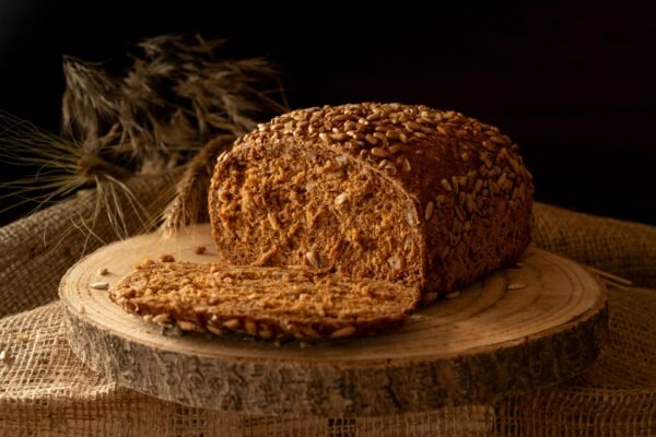 Freshly baked wholegrain bread loaf with sunflower seeds, perfect for breakfast.